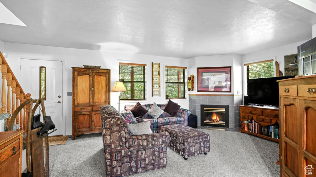 Carpeted living room with a fireplace