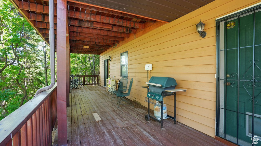 Wooden deck featuring area for grilling