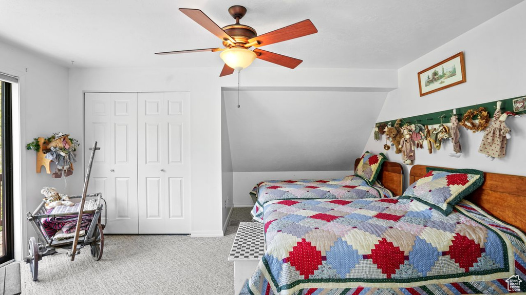 Carpeted bedroom featuring a closet and ceiling fan