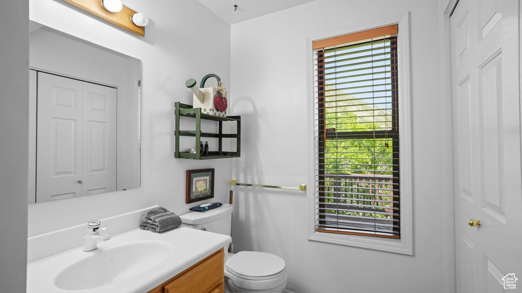 Bathroom with plenty of natural light, vanity, and toilet