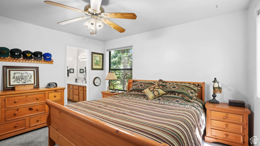 Bedroom featuring carpet, connected bathroom, and ceiling fan