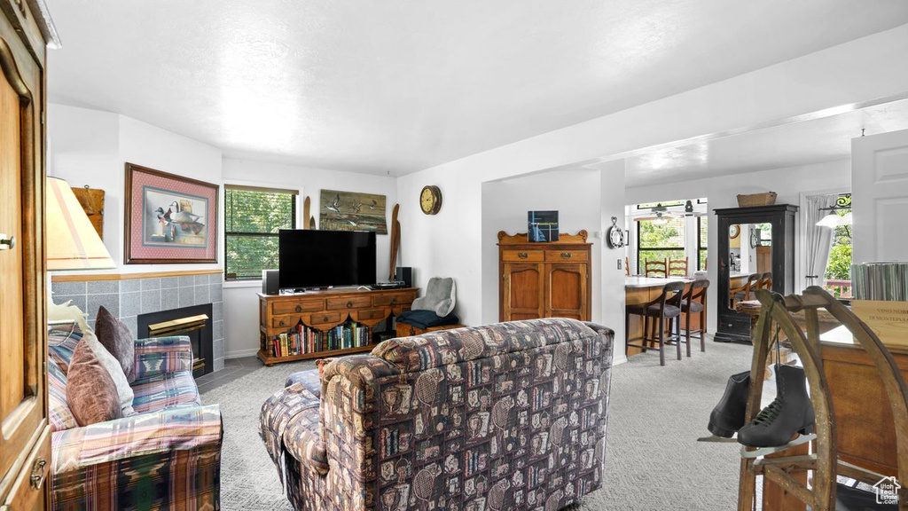 Living room with a tile fireplace and light carpet