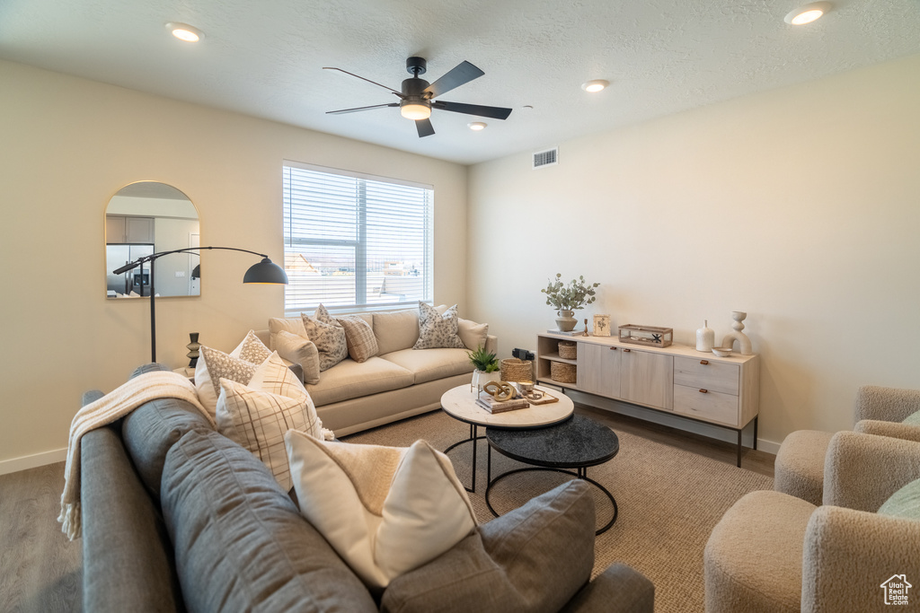 Living room with hardwood / wood-style floors and ceiling fan