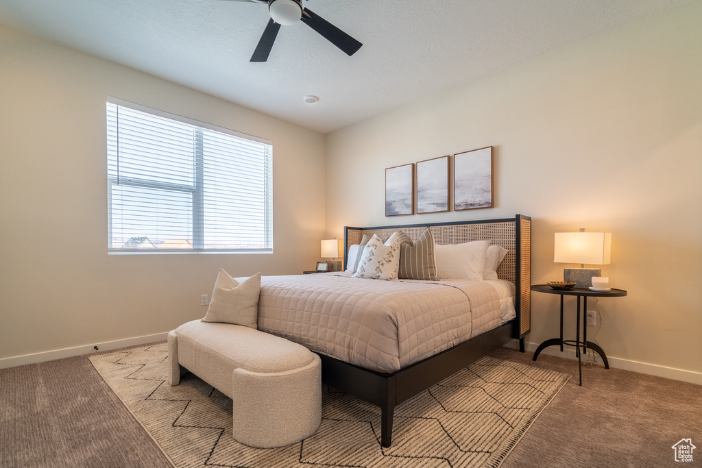 Carpeted bedroom with ceiling fan