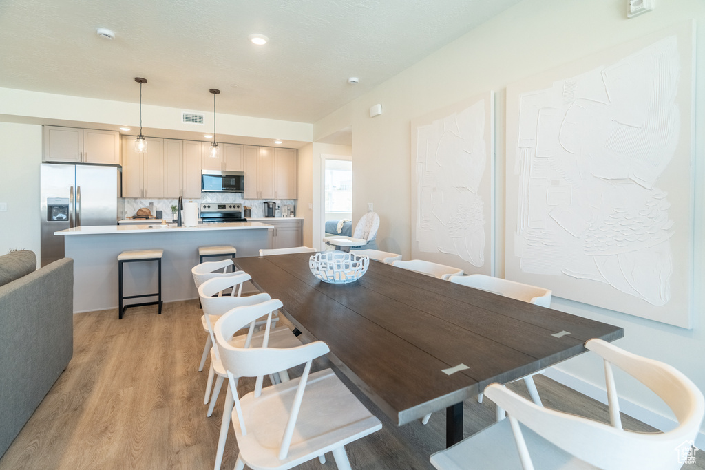 Dining room with light hardwood / wood-style floors