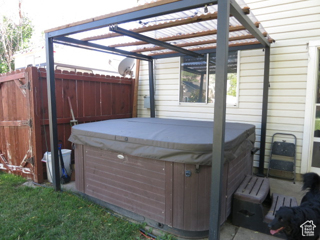 Wooden terrace featuring a pergola and a hot tub