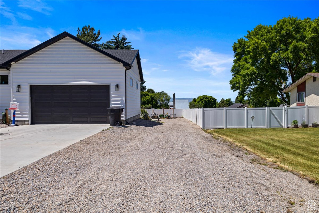 View of property exterior with a yard