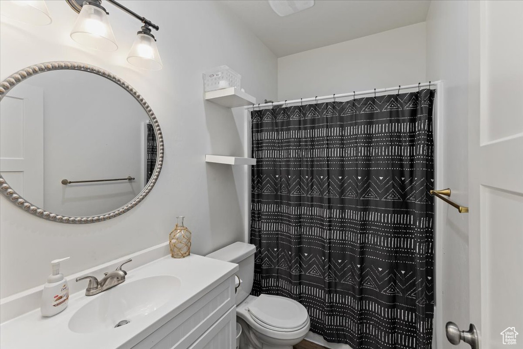 Bathroom featuring toilet and large vanity