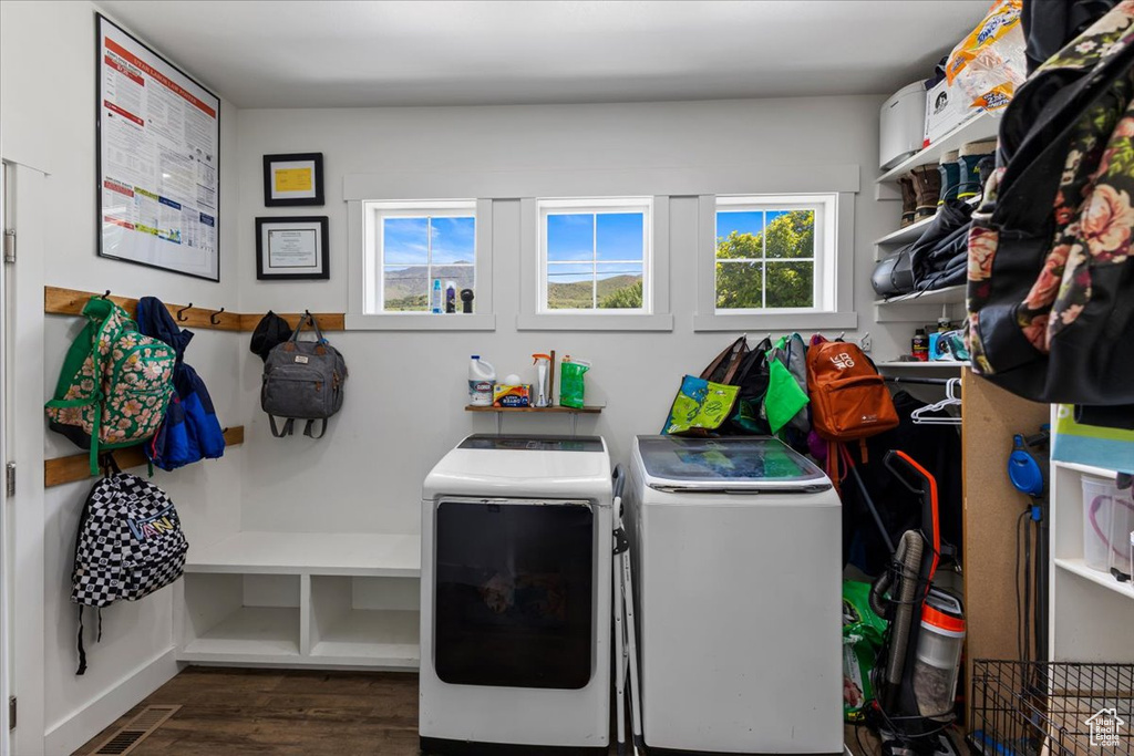 Laundry room featuring dark wood-type flooring and independent washer and dryer