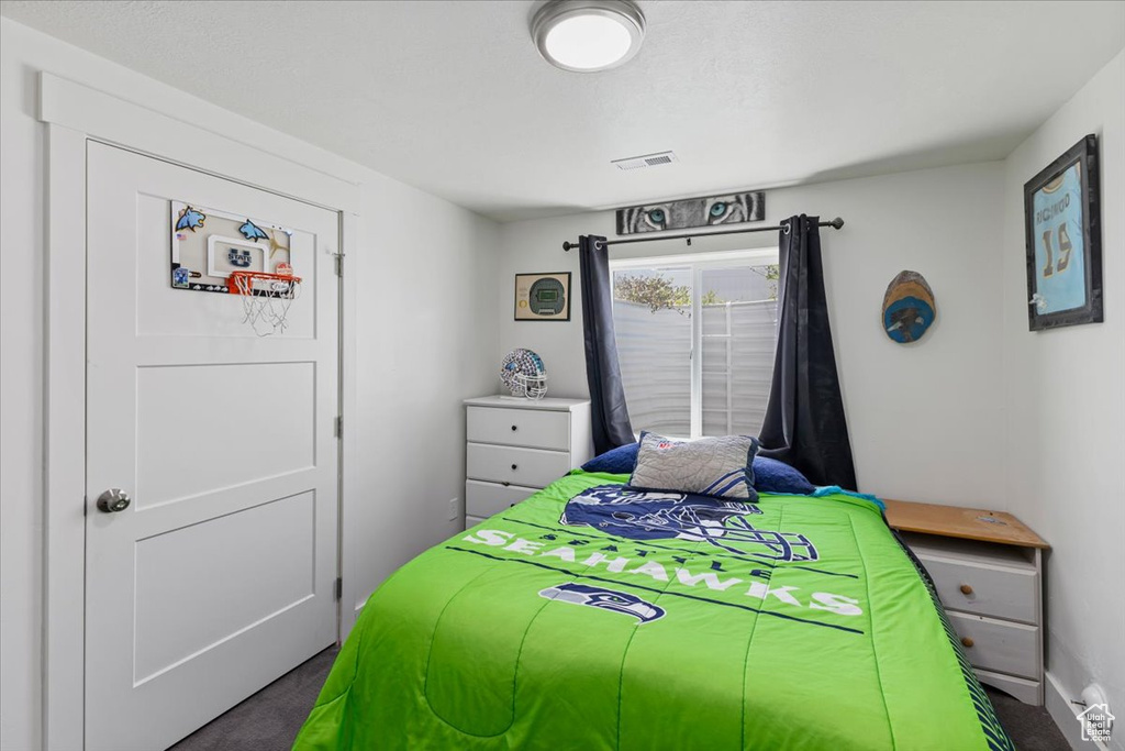 Bedroom with dark colored carpet