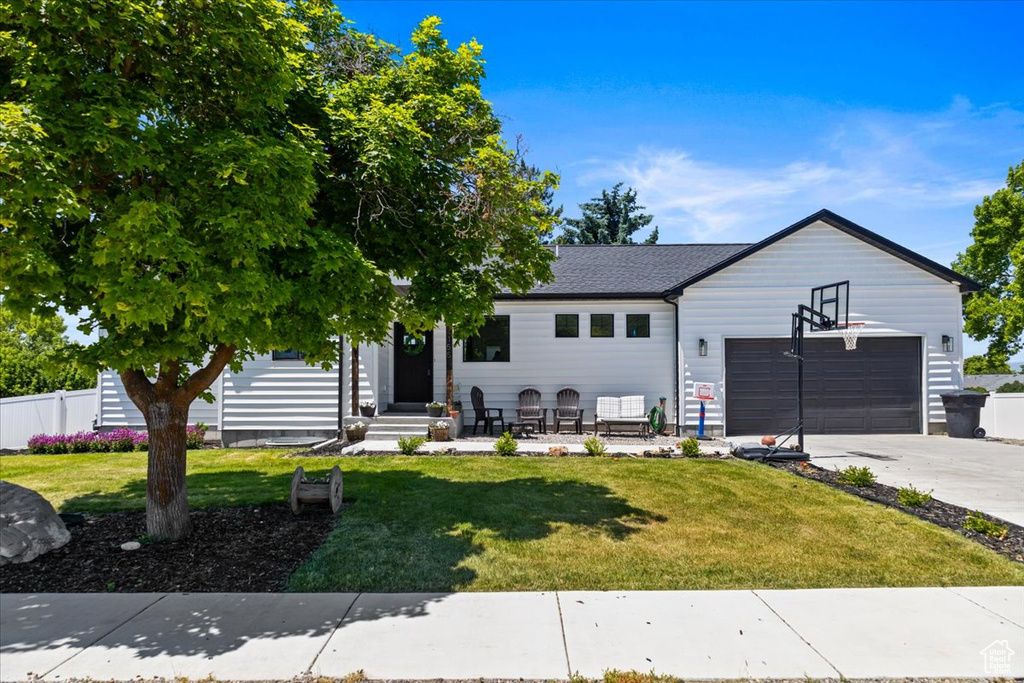 View of front of home featuring a garage and a front yard