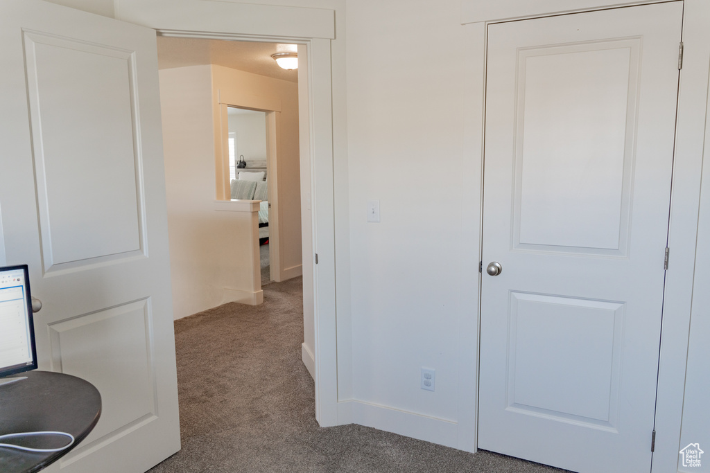 Hall featuring carpet flooring