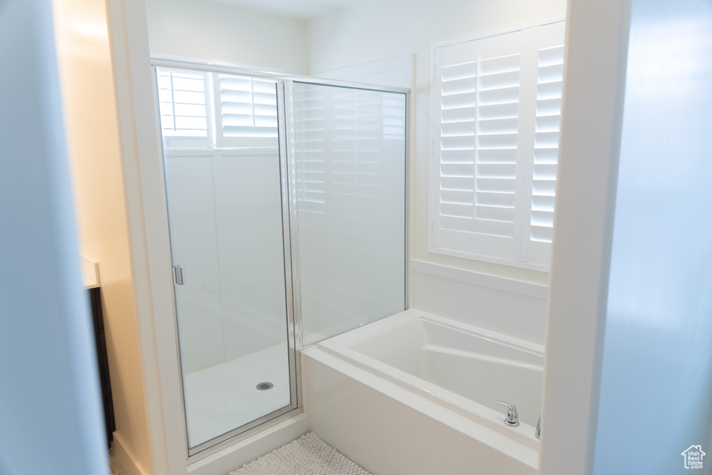 Bathroom featuring shower with separate bathtub