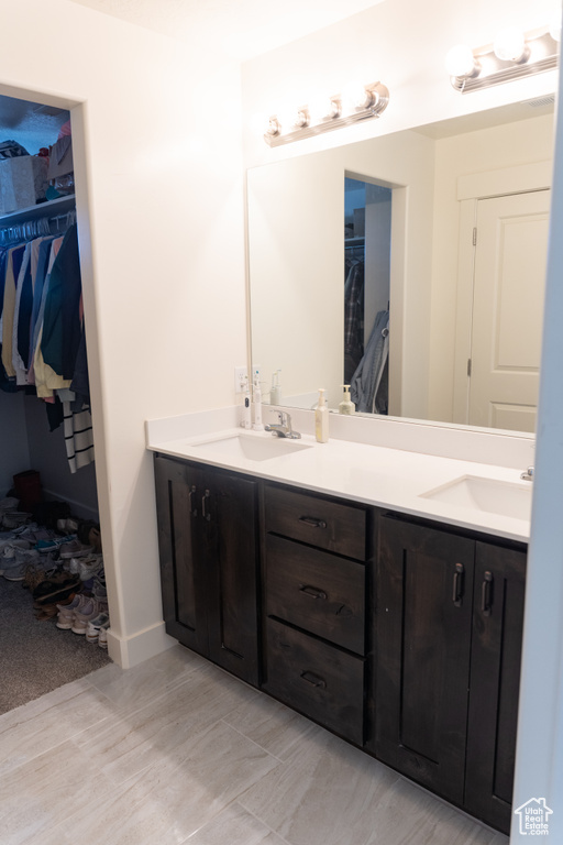 Bathroom with double vanity and tile floors