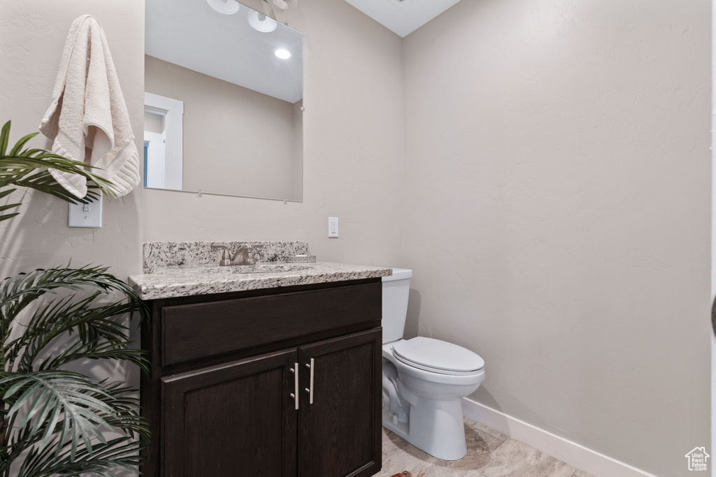 Bathroom featuring tile flooring, vanity, and toilet