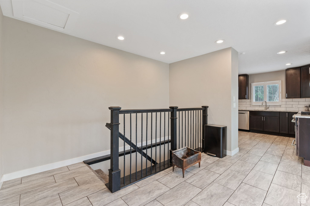 Hallway featuring sink and light tile floors