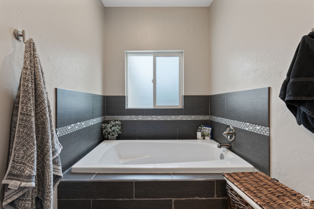 Bathroom with tiled bath