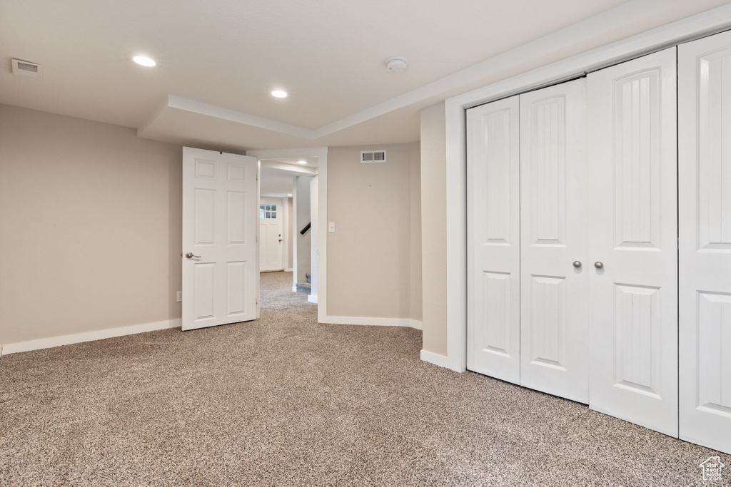 Unfurnished bedroom featuring a closet and carpet floors