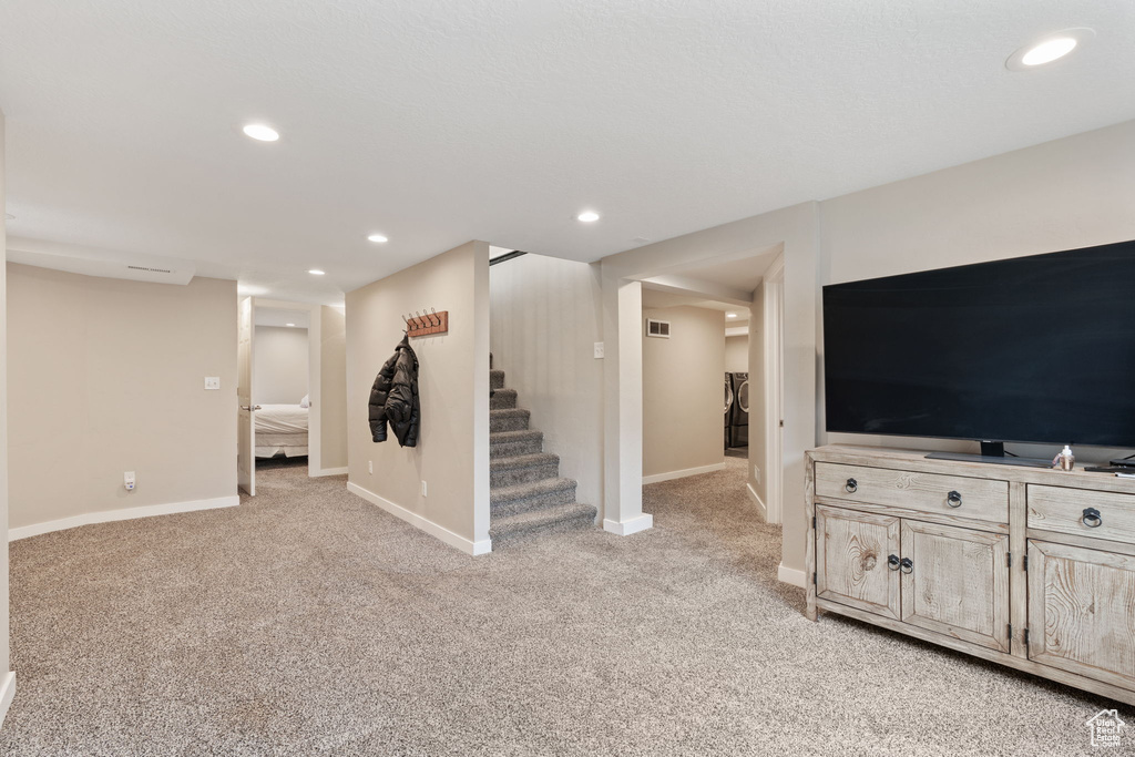 Unfurnished living room featuring light colored carpet