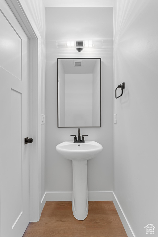 Bathroom with hardwood / wood-style floors