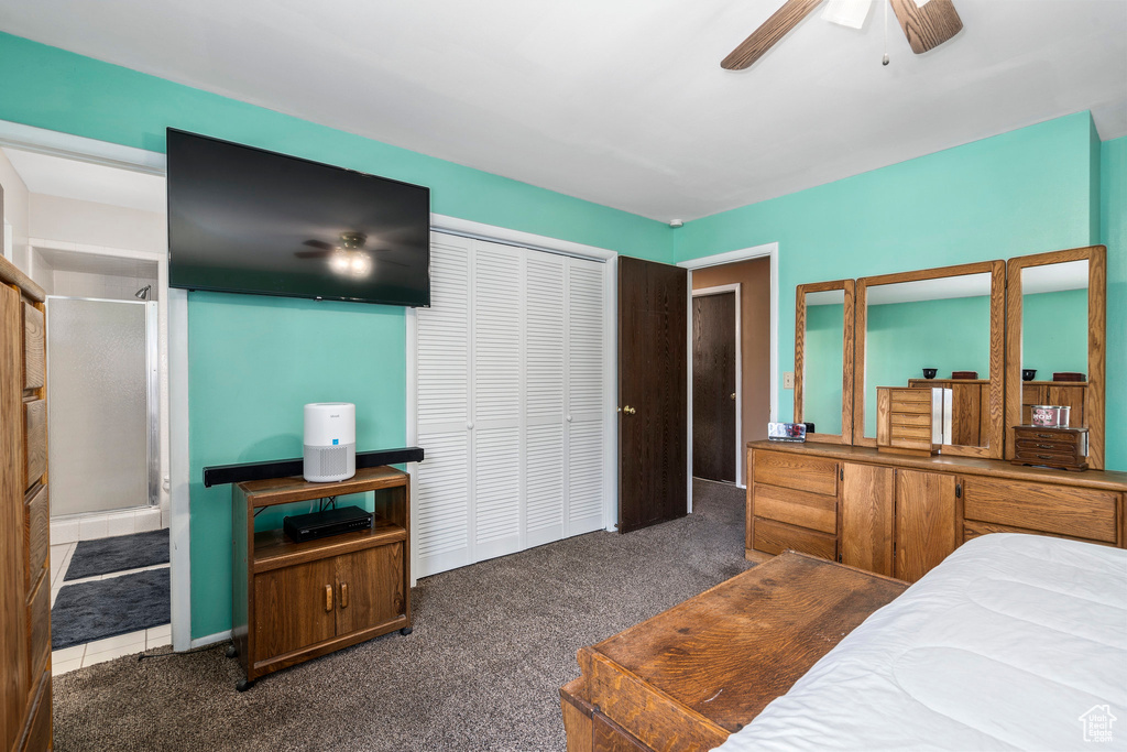 Bedroom with ceiling fan, a closet, and dark carpet