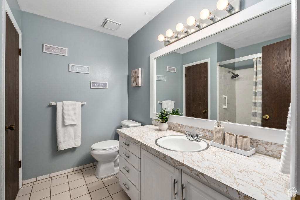 Bathroom with tile floors, toilet, and vanity