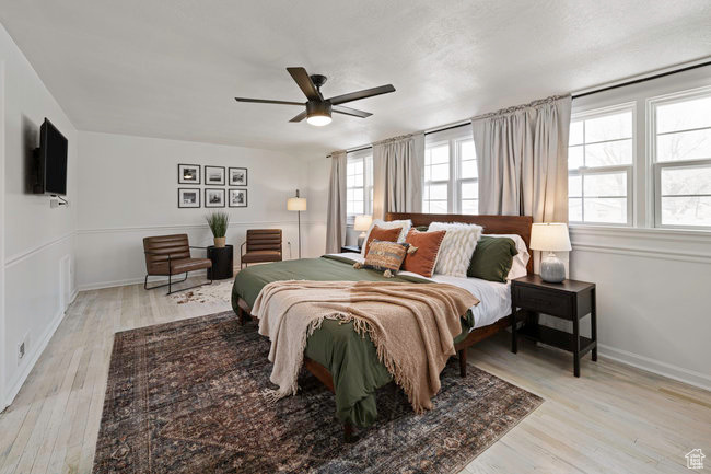 Bedroom with light hardwood / wood-style floors and ceiling fan