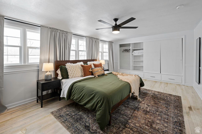 Bedroom featuring ceiling fan and light hardwood / wood-style flooring