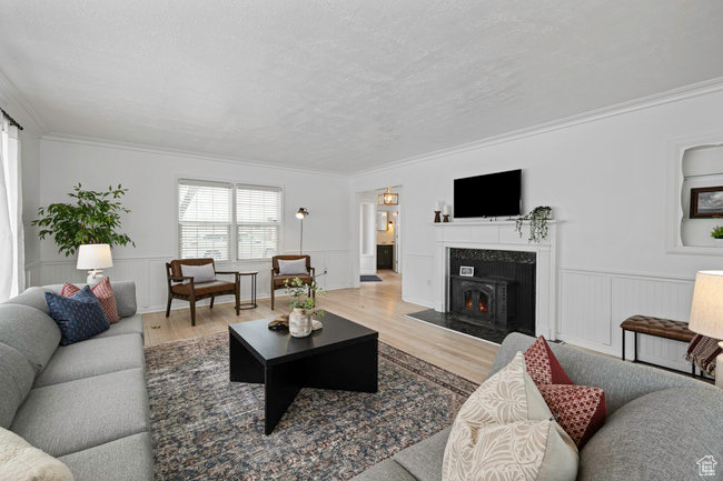 Living room featuring ornamental molding and wood-type flooring