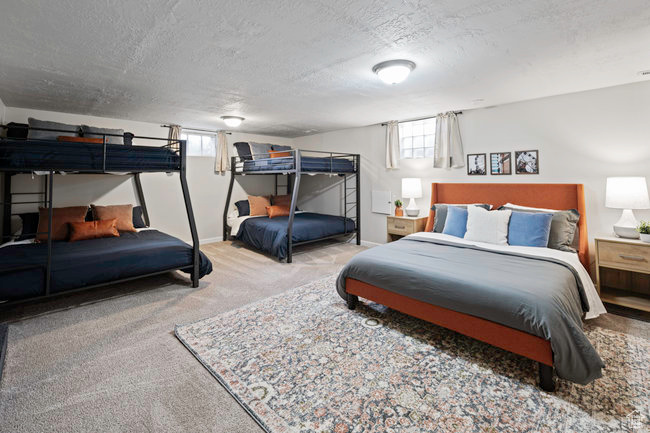 Bedroom featuring a textured ceiling and carpet flooring