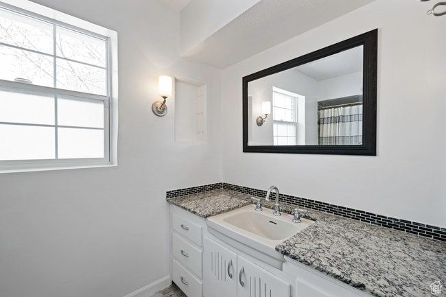 Bathroom with vanity with extensive cabinet space