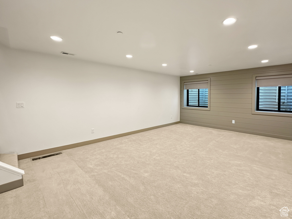 Empty room featuring light colored carpet