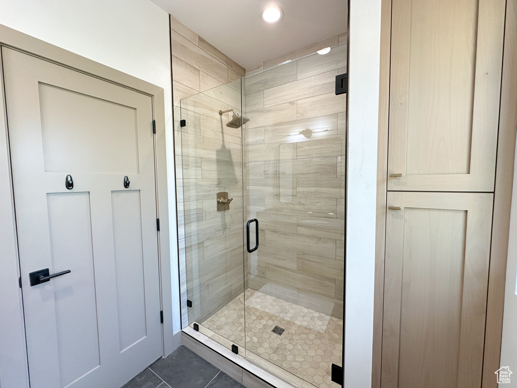 Bathroom with tile floors and a shower with door