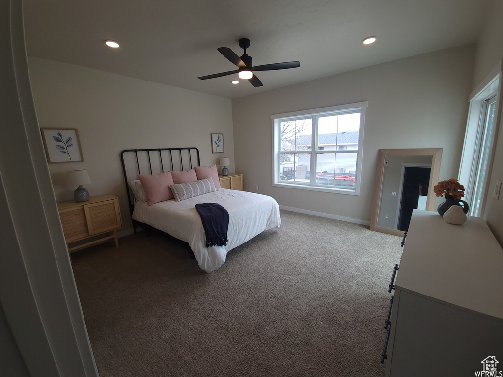 Bedroom with ceiling fan and dark carpet