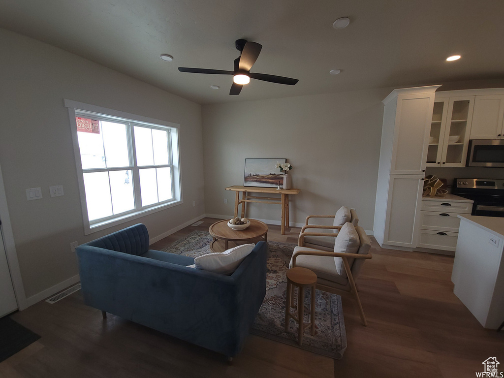 Living room featuring ceiling fan and hardwood / wood-style floors