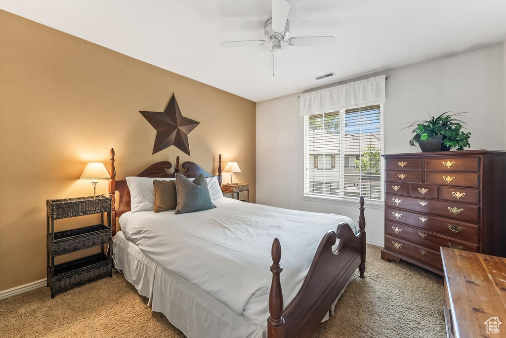 Carpeted bedroom with ceiling fan