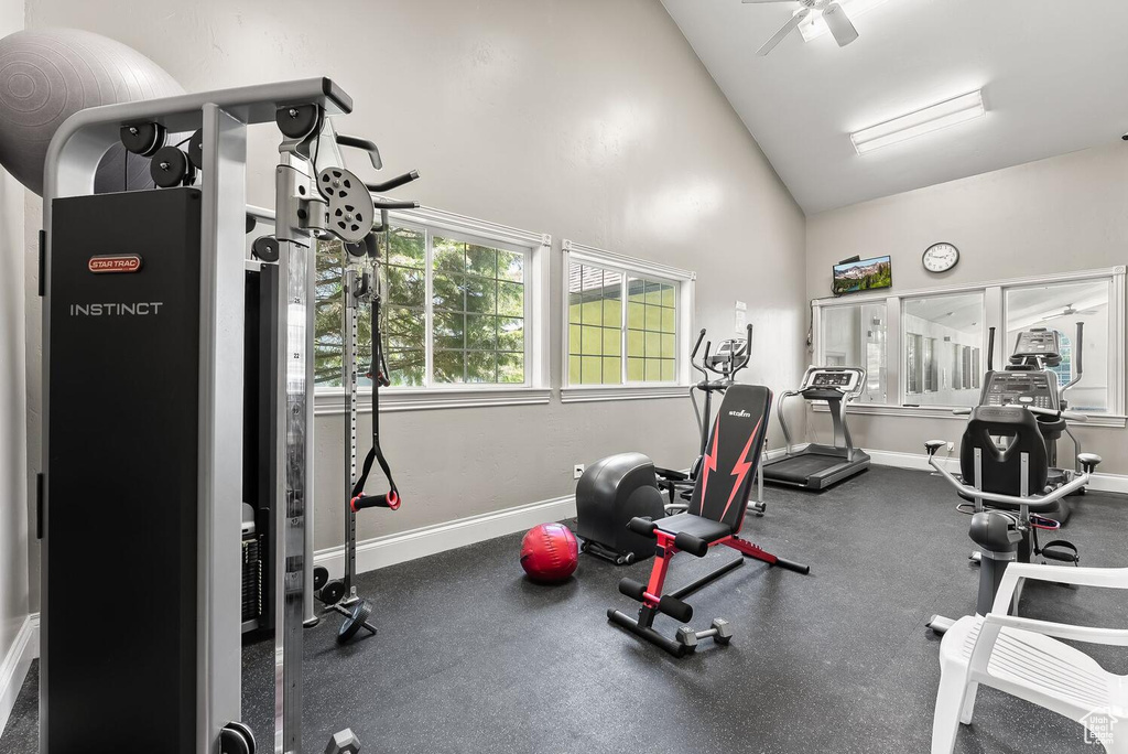 Workout area with ceiling fan and lofted ceiling