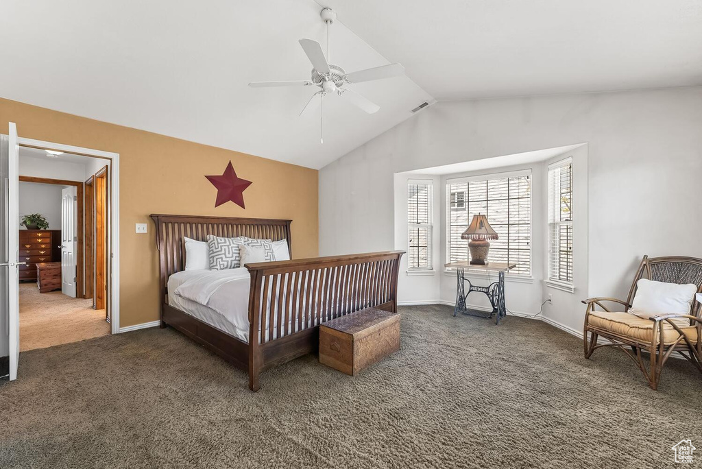 Bedroom featuring lofted ceiling, dark colored carpet, and ceiling fan