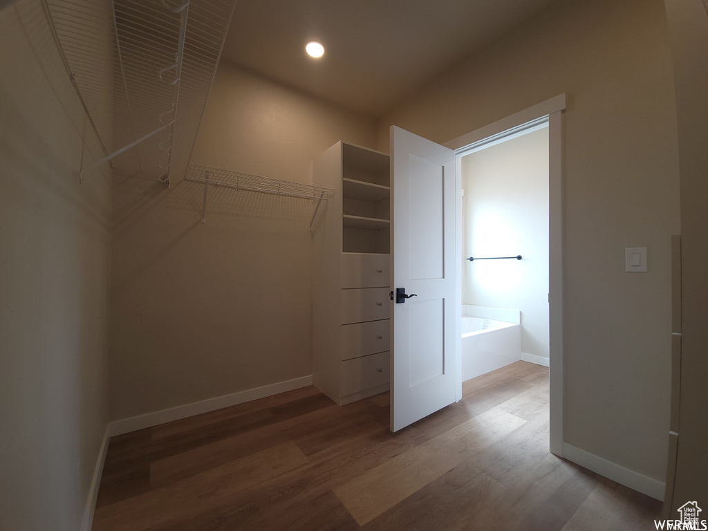 Walk in closet featuring wood-type flooring