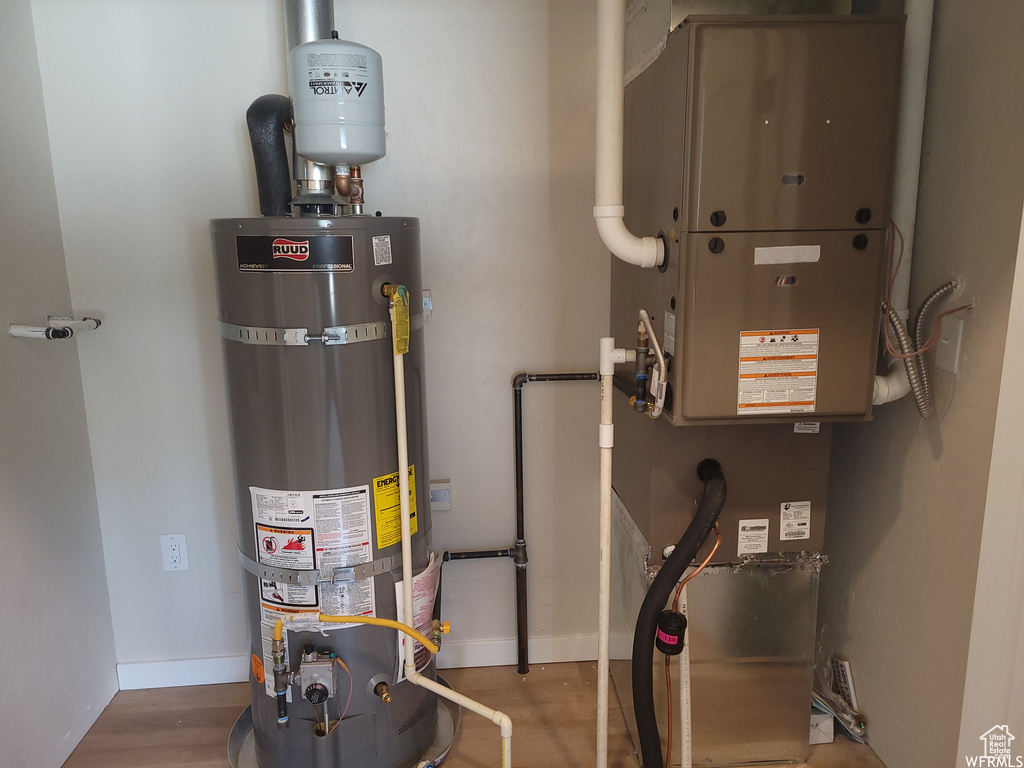 Utility room featuring heating utilities and water heater