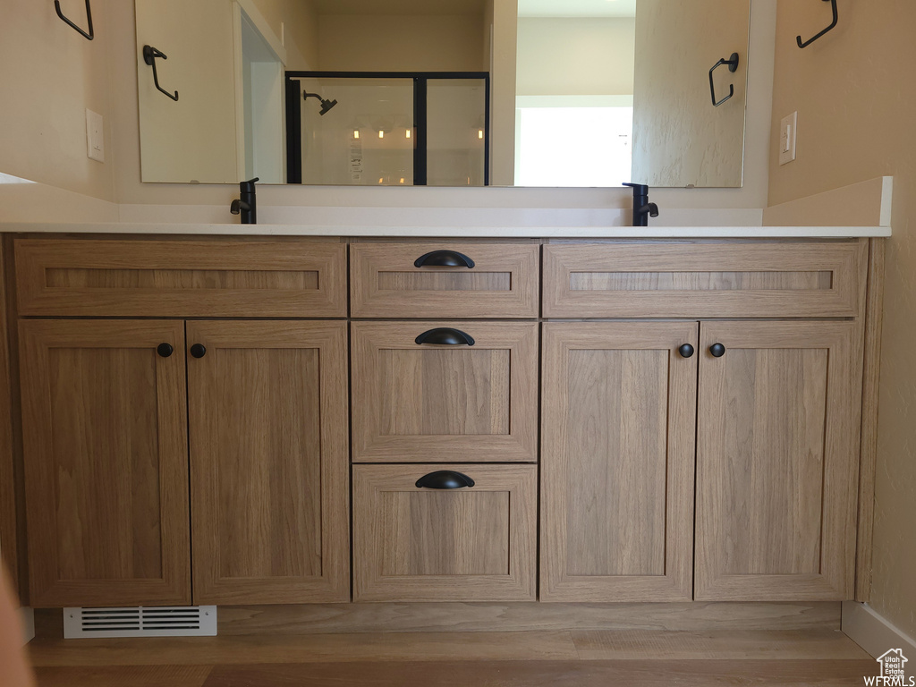 Bathroom with vanity and hardwood / wood-style flooring