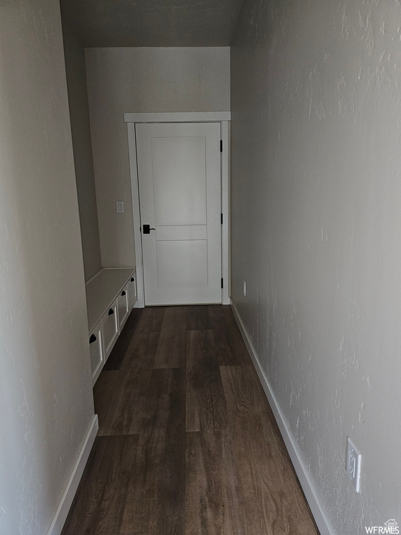 Corridor with hardwood / wood-style floors