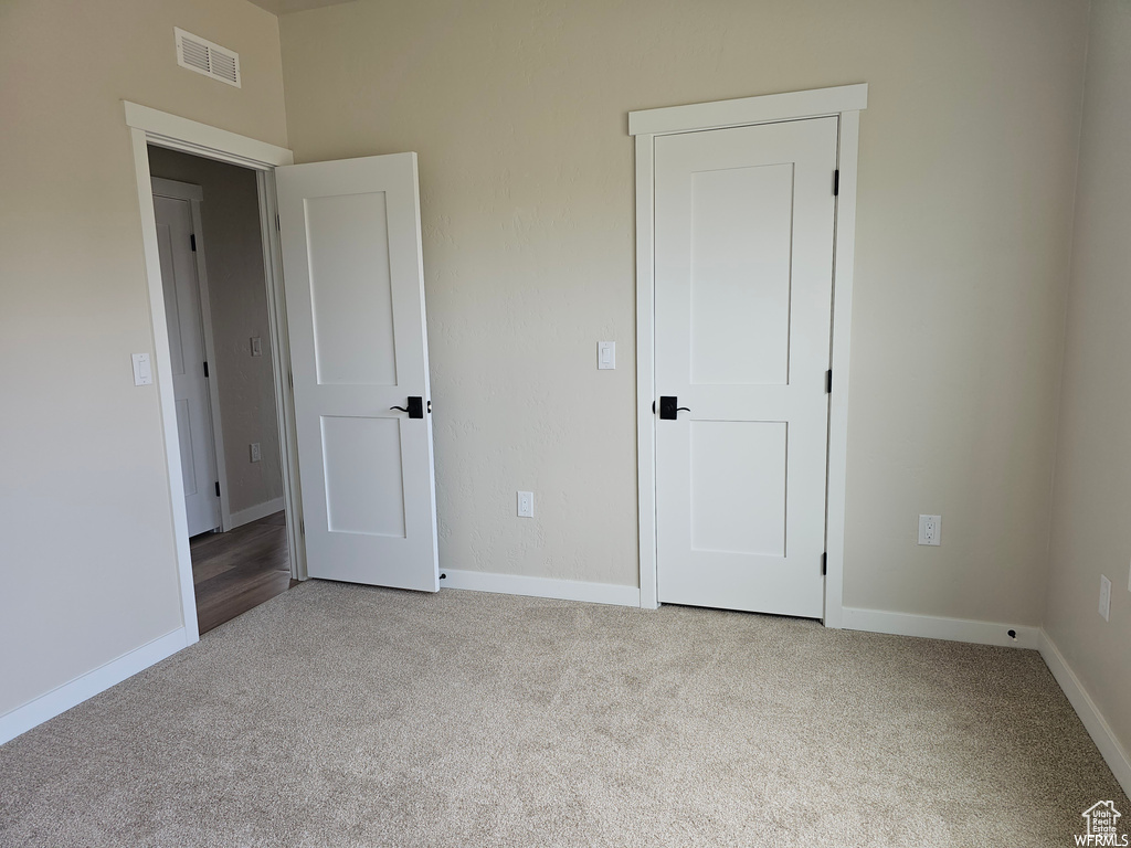 Unfurnished bedroom with carpet floors