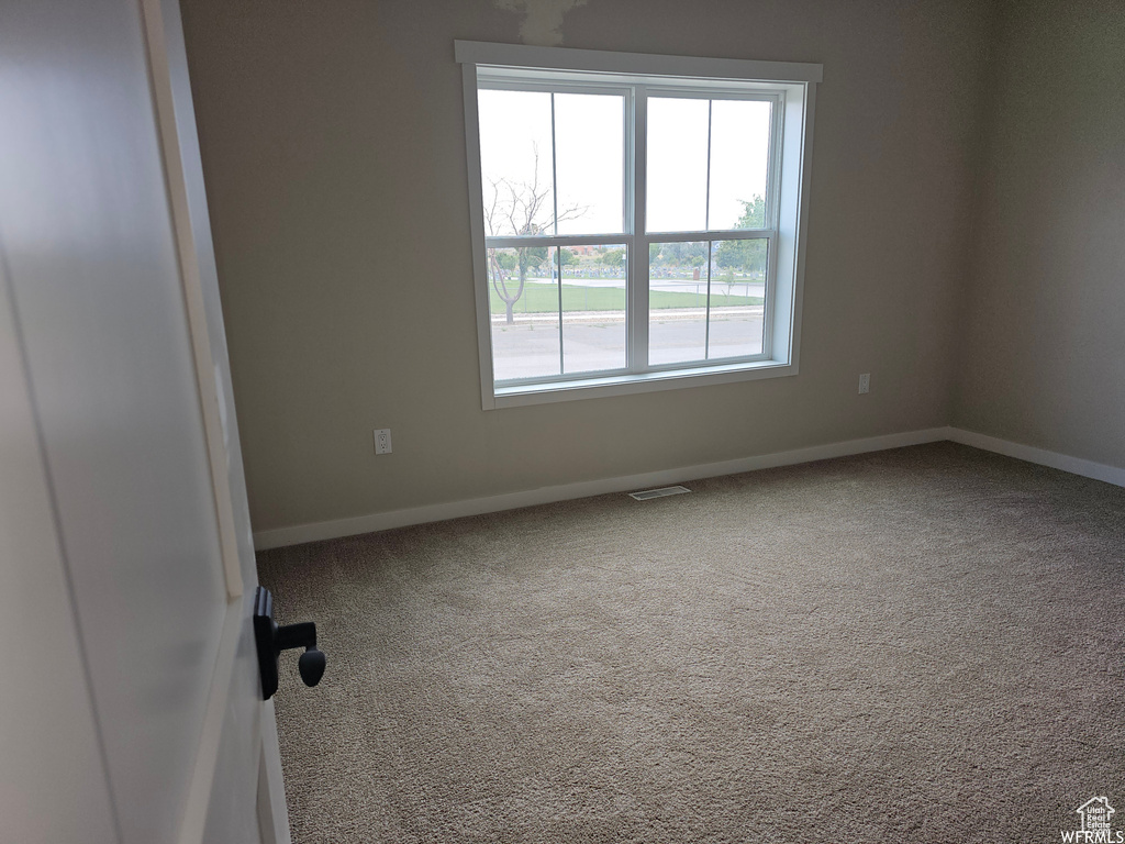 Unfurnished room featuring carpet