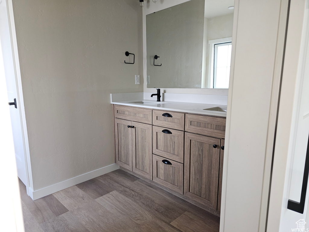 Bathroom featuring hardwood / wood-style flooring and vanity