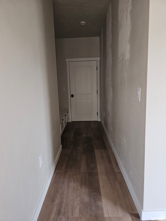 Corridor featuring hardwood / wood-style flooring