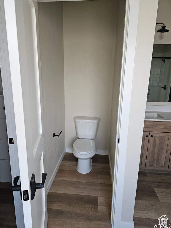 Bathroom with vanity, toilet, and hardwood / wood-style floors