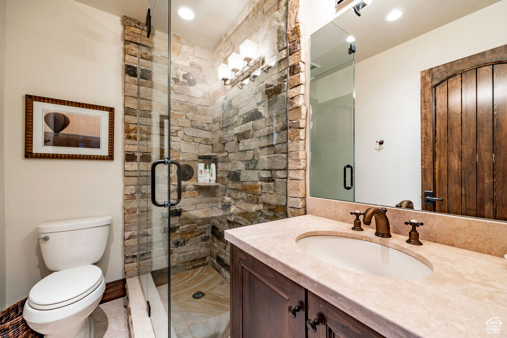 Bathroom featuring vanity and a stall shower