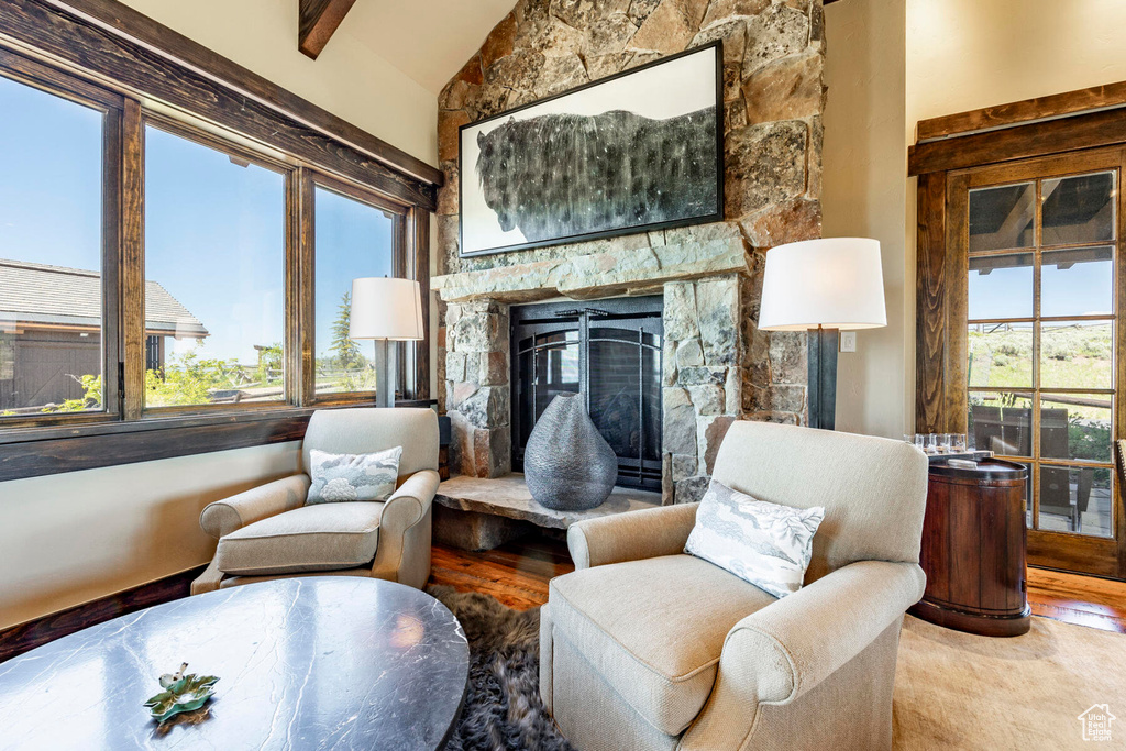 Sitting room featuring lofted ceiling, wood finished floors, and a fireplace