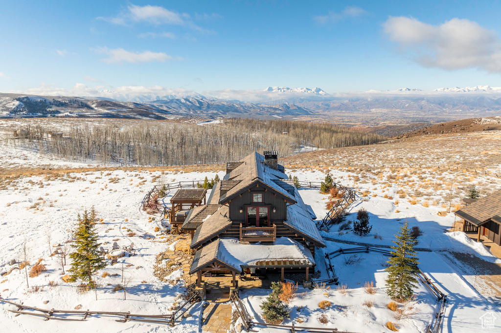 Snowy aerial view featuring a mountain view